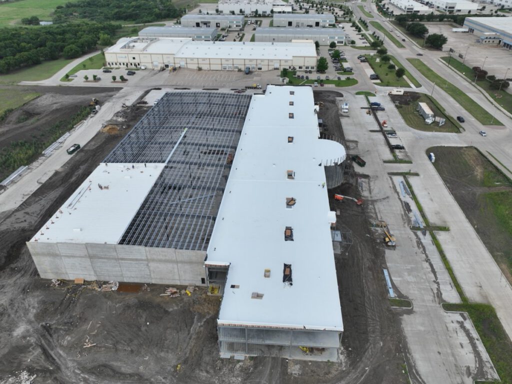 Aerial view of a commercial TPO roofing installation project in Texas